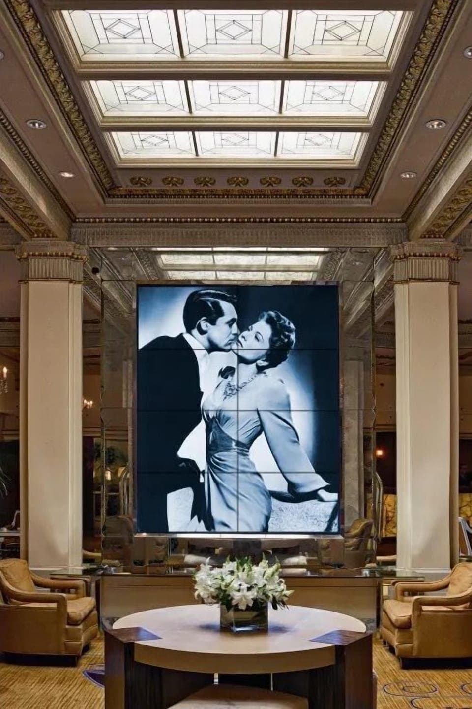 The grand lobby area is adorned with luxurious furnishings and exquisite artwork, offering a serene space for guests.