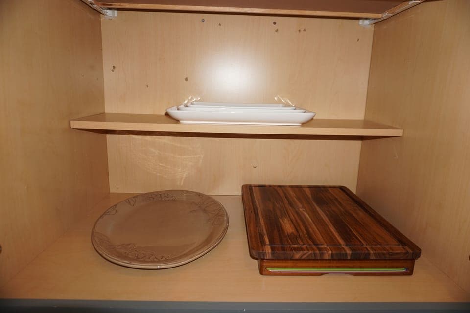 Wood & plastic cutting boards & and assortment of serving trays.