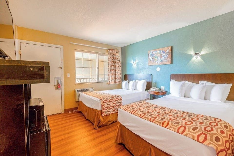 Spread out comfortably with two plush beds and soft lighting.
