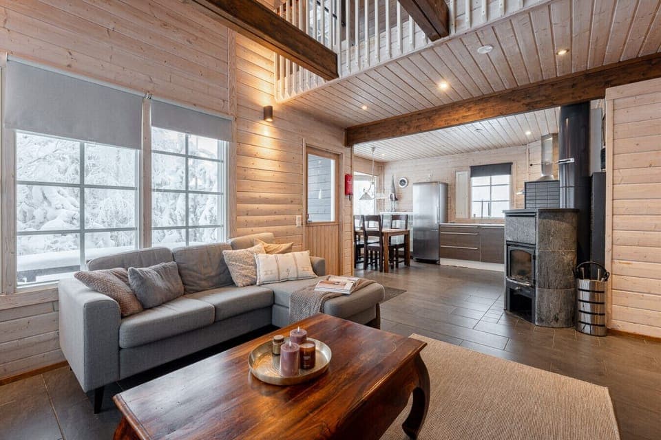 The spacious living room is the heart of the home, where high ceilings and large windows create a sense of airiness.