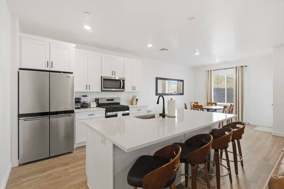 Fully equipped modern kitchen with large island and bar seating.
