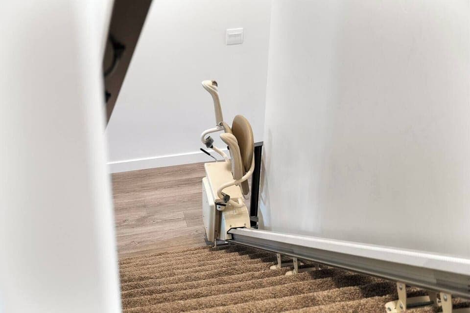 Staircase equipped with a stair lift for added accessibility.