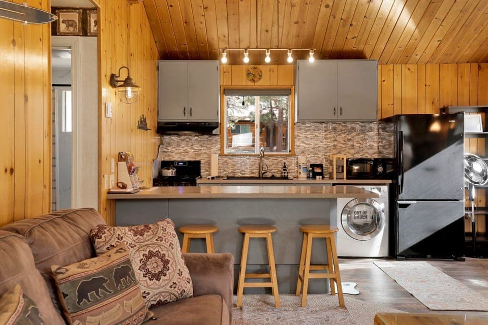 Fully equipped cabin kitchen with ample cabinetry, stove, fridge, microwave, and coffee maker—perfect for cooking meals, morning coffee, and feeling right at home on your stay.