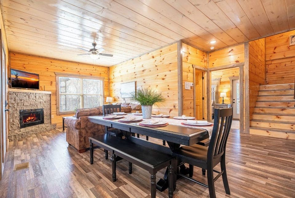 Gather around your rustic dining table while the fireplace crackles nearby, creating the perfect atmosphere for memorable meals together.