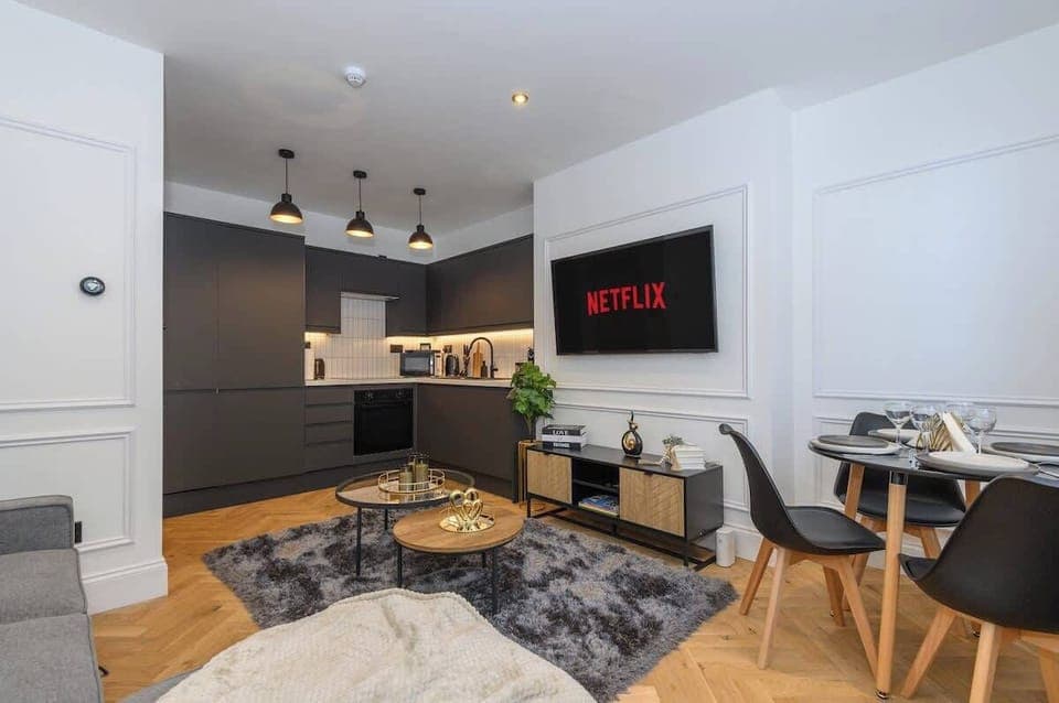 Living room with large smart tv and dinning table
