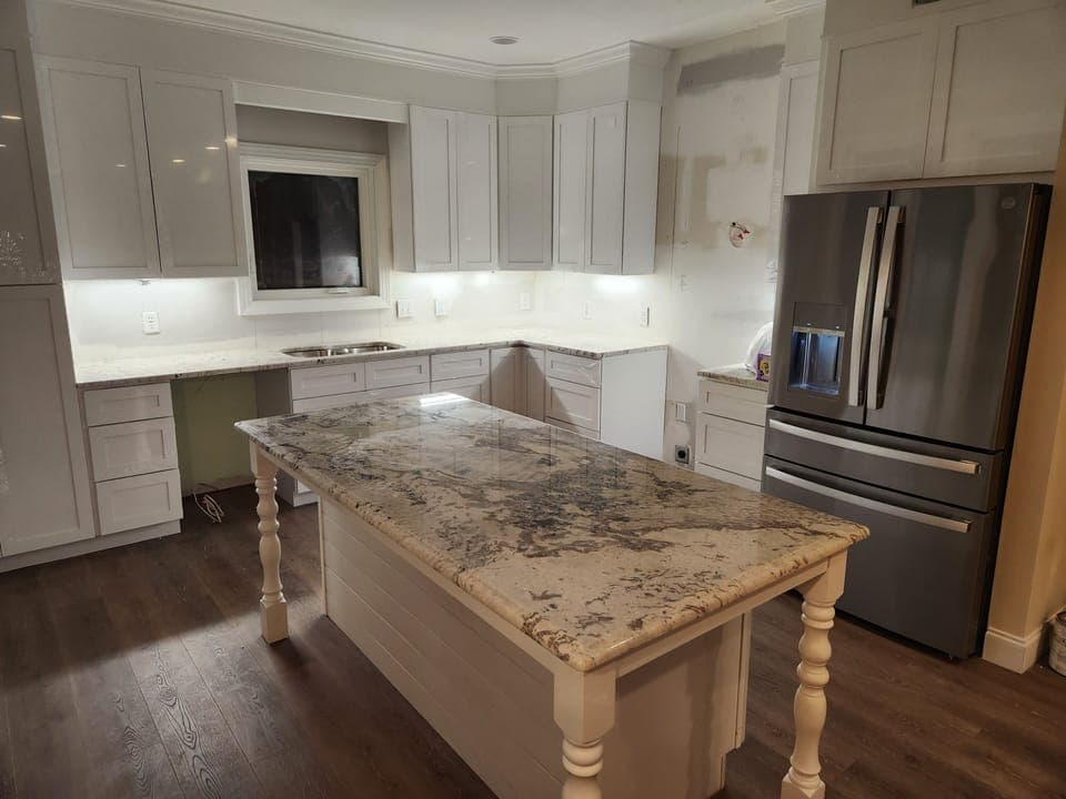 Your gourmet kitchen awaits with elegant granite countertops, stainless steel appliances, and a spacious island perfect for preparing memorable meals together.