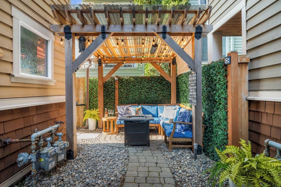Relax under the pergola in our cozy backyard seating area