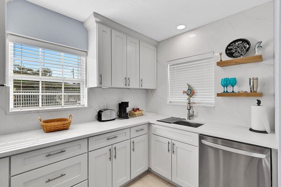 Fully equipped kitchen with fridge, oven, stove, microwave, toaster, coffee maker, basic cooking utensils, dishware, and more!