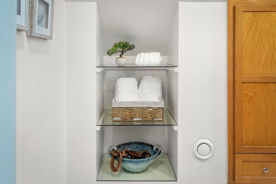 Fresh towels and extra essentials are neatly stored and ready for your use.