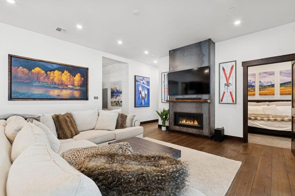 Unwind in this elegant living room where cozy seating surrounds a warm fireplace, perfect for your evening relaxation.