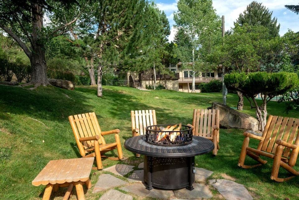 Relax on the lawn as flames crackle under tall pines.