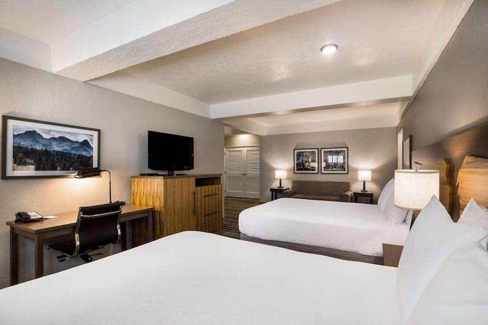 Gather comfortably with two beds, sofa seating, and ample space.
