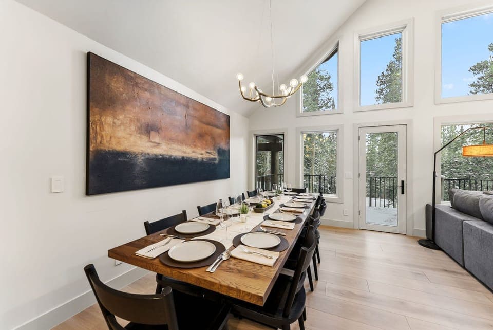 Dining area with seating for 10 guests and 2 additional barstools to the kitchen counter.