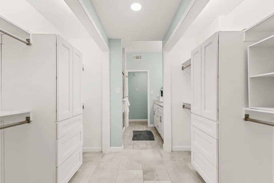 Enjoy a bright, roomy bathroom setup with ample counter space and storage — perfect for getting ready comfortably during your stay.