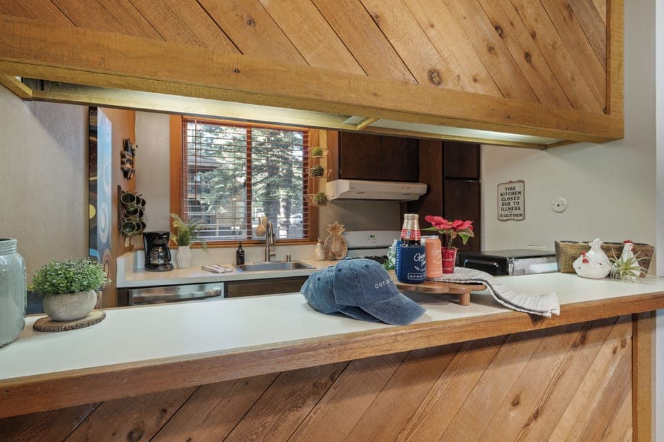 Cozy kitchen with a convenient pass-through window and warm wood accents.