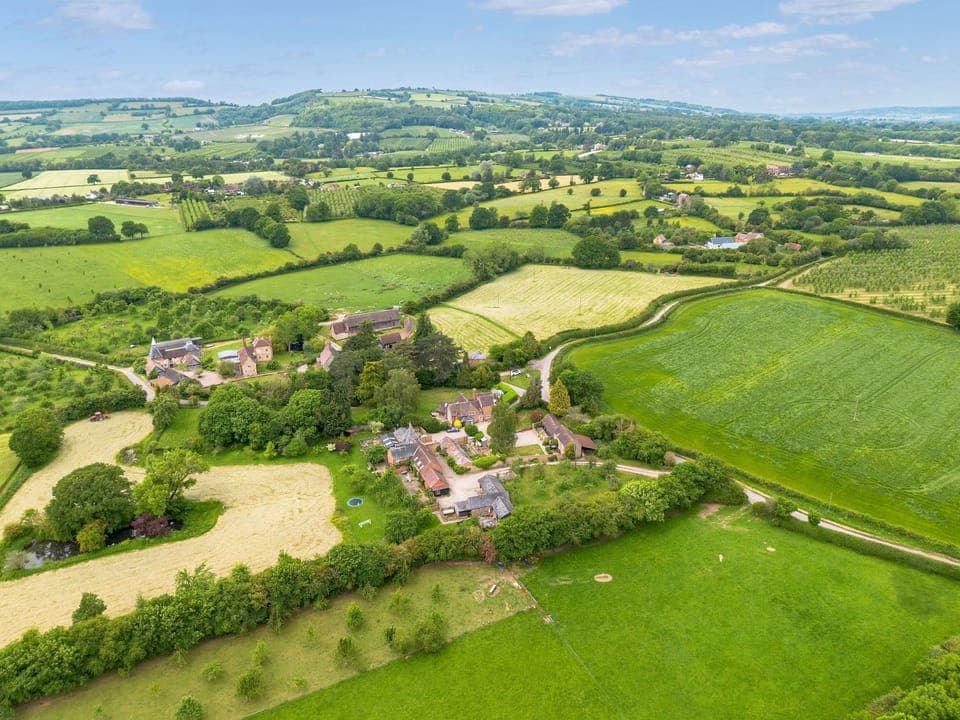 Aerial view over White House Cottages with Malvern Hills behind
