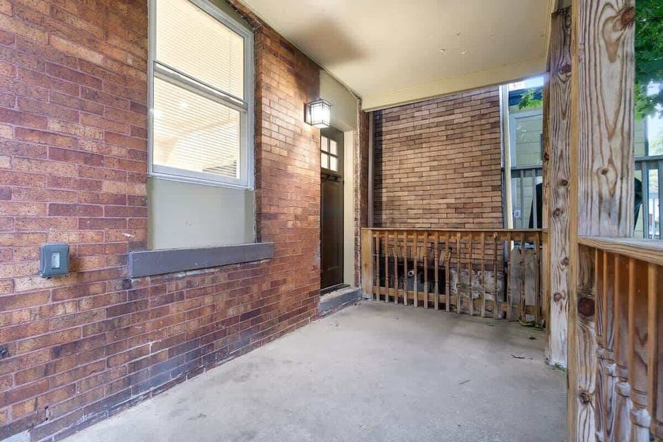 Spacious fenced backyard with mature trees and a covered patio — perfect for morning coffee, evening relaxation, or letting pets enjoy the outdoors.