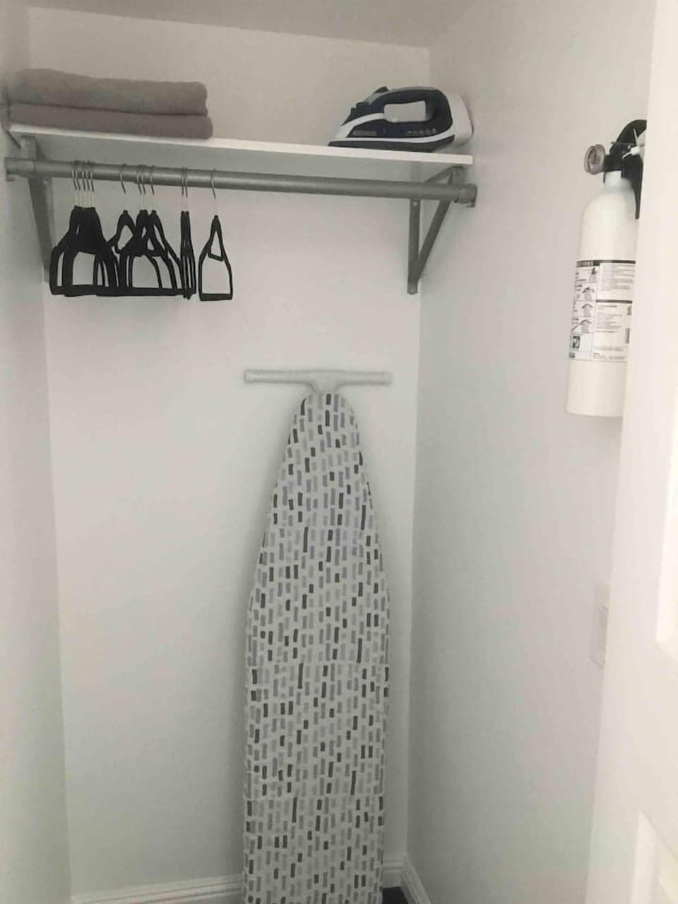 For your convenience, this dedicated utility space provides a full-sized ironing board, an iron, extra linens, and hanging space, ensuring you have everything you need to feel perfectly settled during your stay.