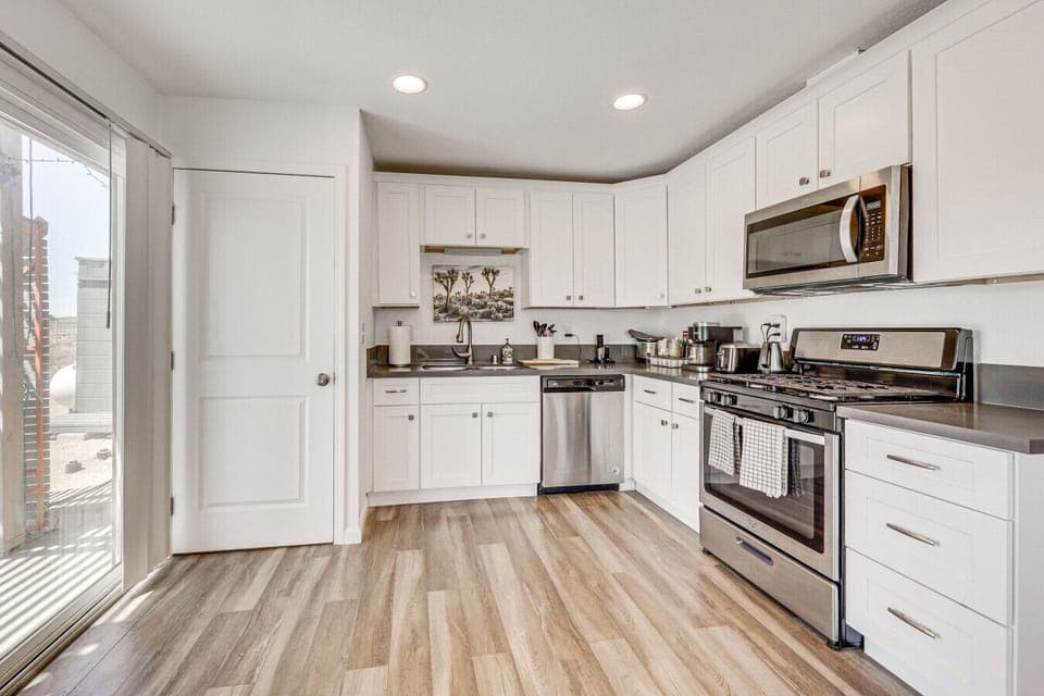 Kitchen | Stainless Steel Appliances | White Cabinetry & Recessed Lighting