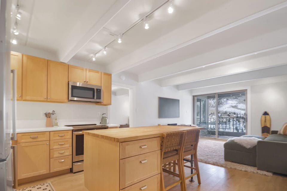 Unwind in your bright open-plan space where warm wood meets mountain views through your private balcony.