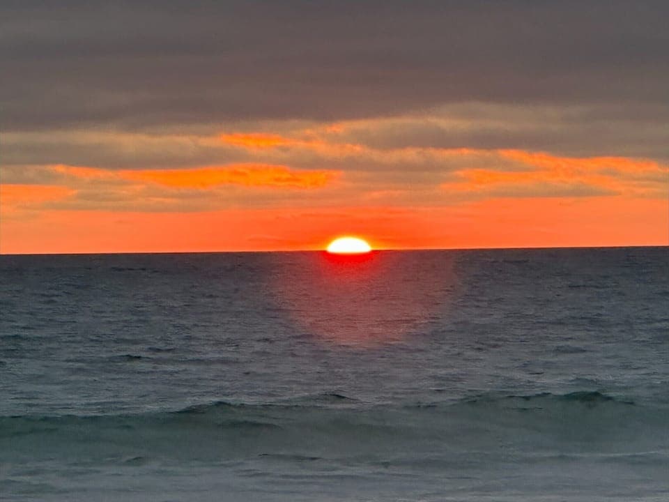 Gorgeous sunsets steps away from this near ocean front condo.  2 houses beach.