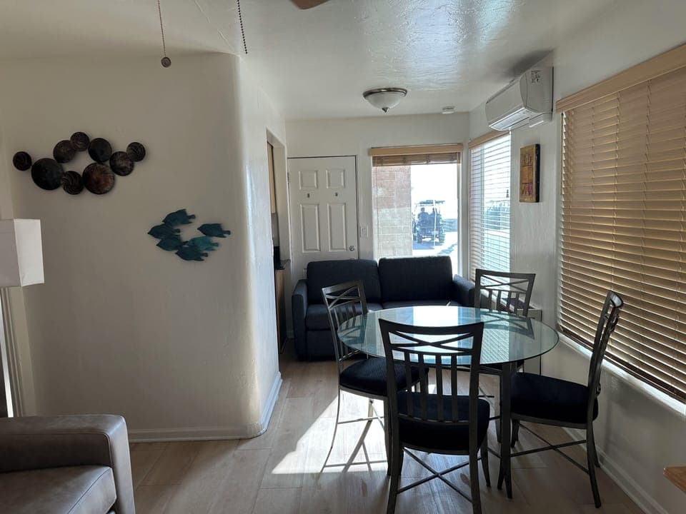 Nicely appointed living room with wood floors, two queen sleeper sofas, etc.
