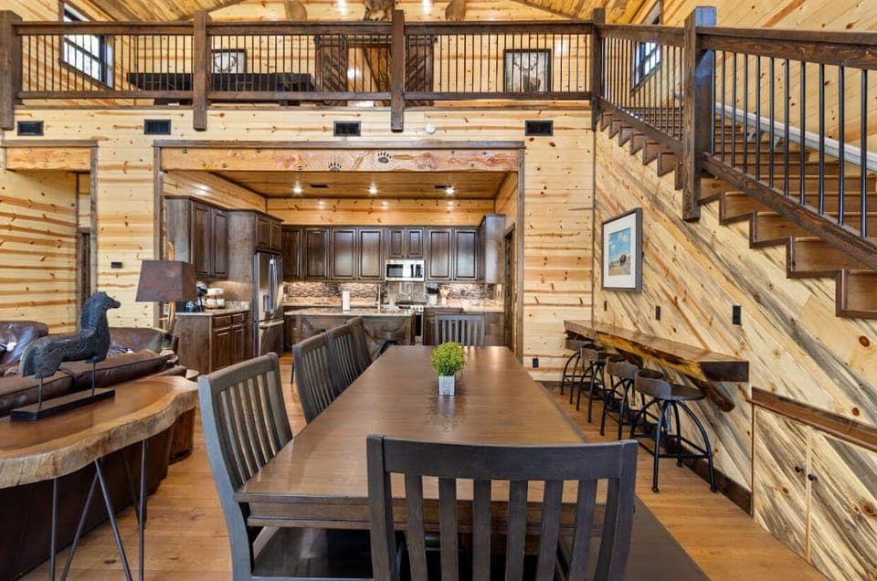 This open-concept space is built for hosting, with a massive dining table and a high-end chef's kitchen.