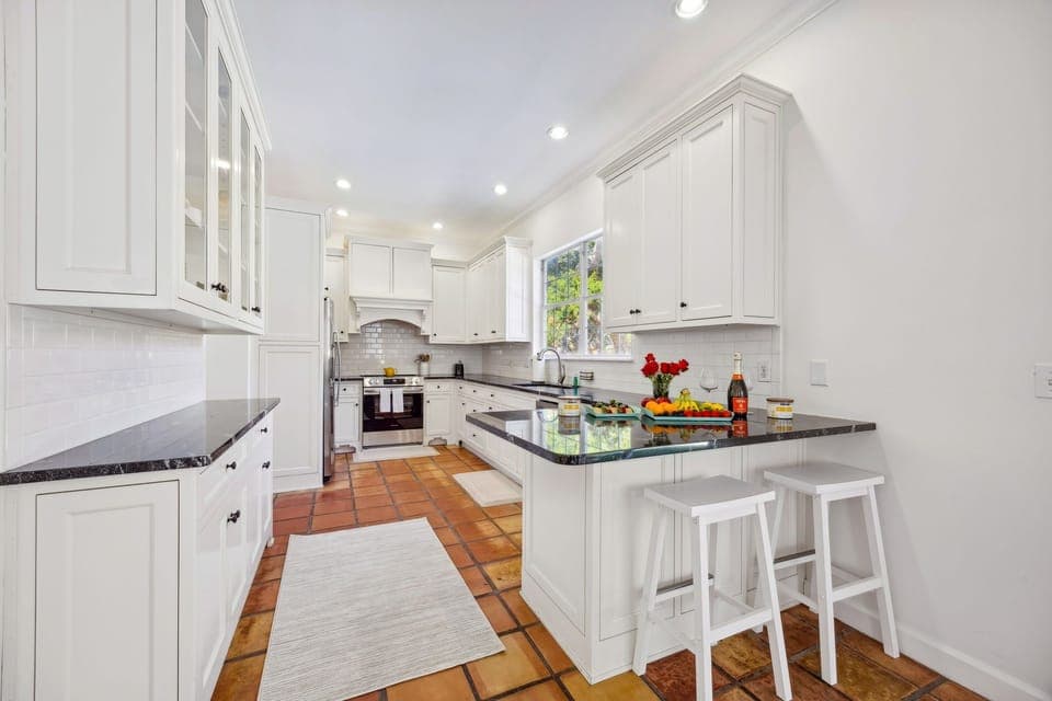 Kitchen: The kitchen is fully stocked with pots, pans, plates, cups, and utensils - Everything you need for home cooked meals.