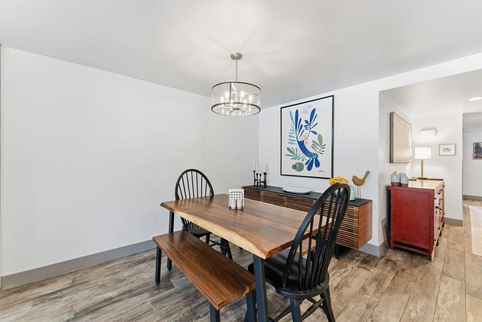 Gather around your stylish dining table where warm wood tones meet modern design, perfect for morning coffee or evening meals together.