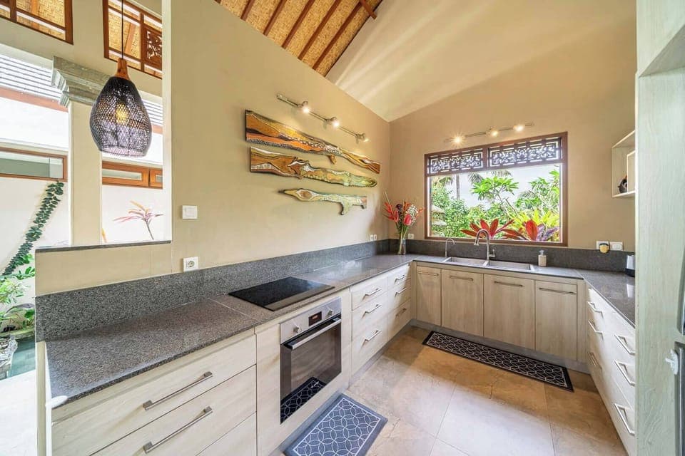 Spacious kitchen with modern appliances and garden outlook
