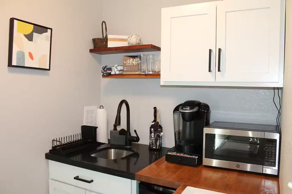 Kitchenette with Keurig and supplies, microwave, mini fridge and toaster.