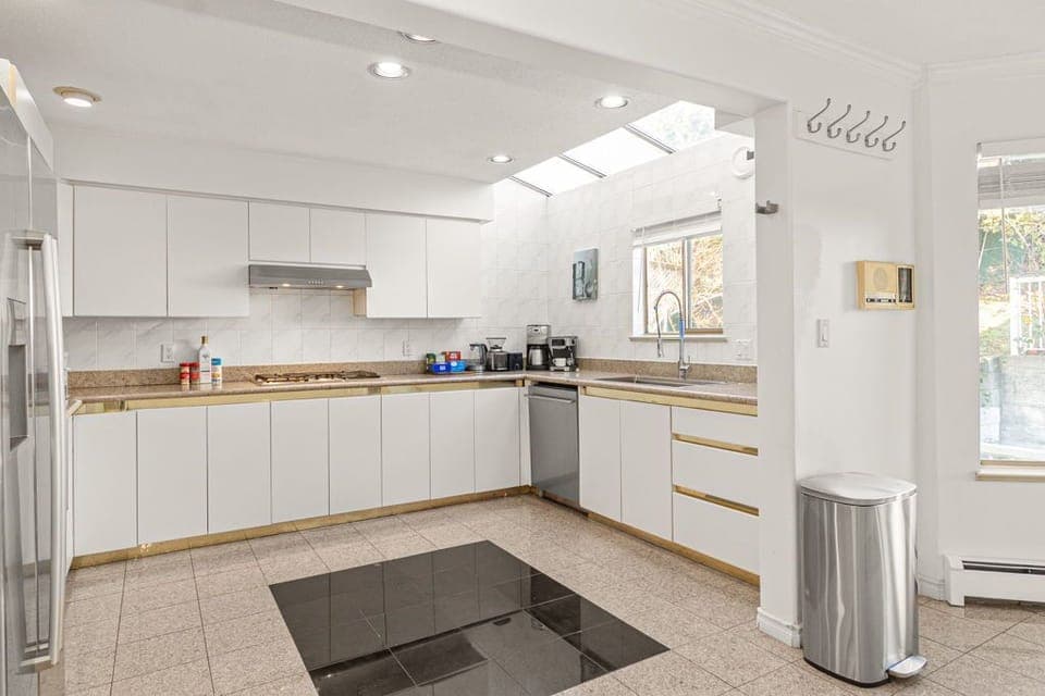 Spacious kitchen with coffee machine, kettle, and basic cooking essentials