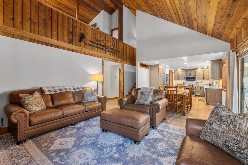 Relax in your cozy leather seating while warm wood beams frame your mountain retreat's open living space.