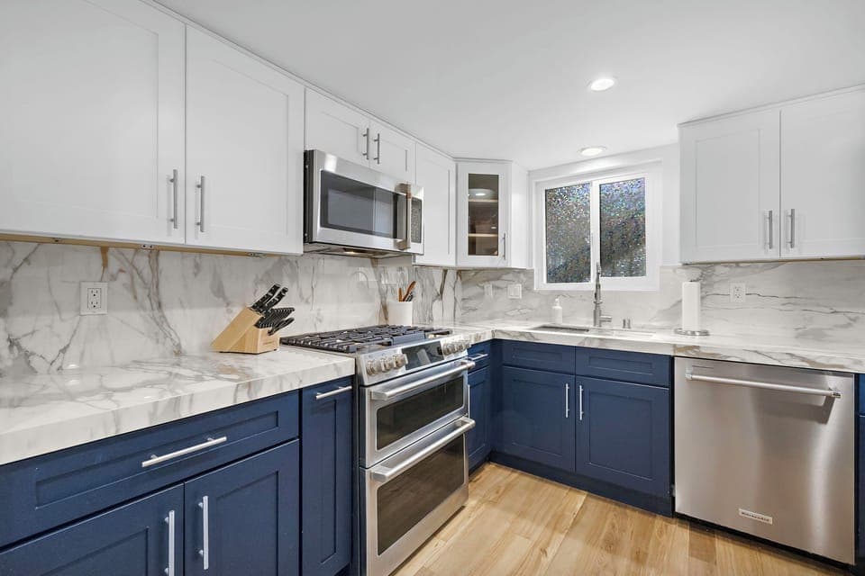 Chef-ready kitchen with custom navy cabinetry, high-end appliances, and a fully stocked setup — complete with all cookware and tools needed to prepare everything from casual meals to a full Thanksgiving feast.