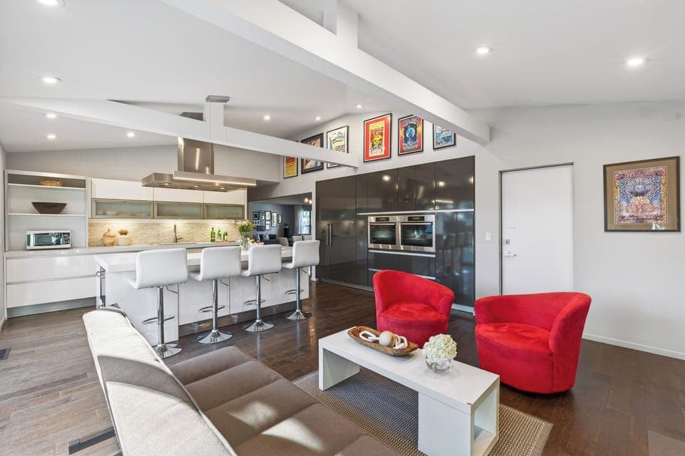 Cozy secondary lounge with fireplace and direct patio access—ideal for quieter moments or a change of scenery.