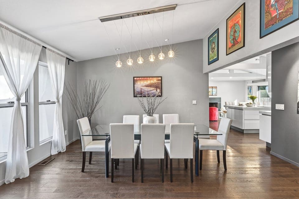 Stylish dining area set beneath statement lighting, perfect for shared meals and lingering conversations.