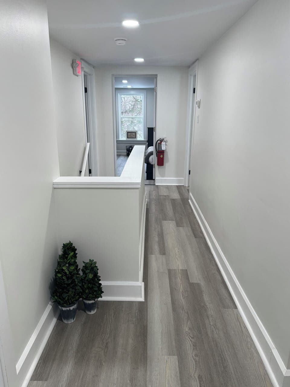 Your modern bathroom features sleek white surfaces and warm wood-tone accents, creating a spa-like retreat for your daily routine.