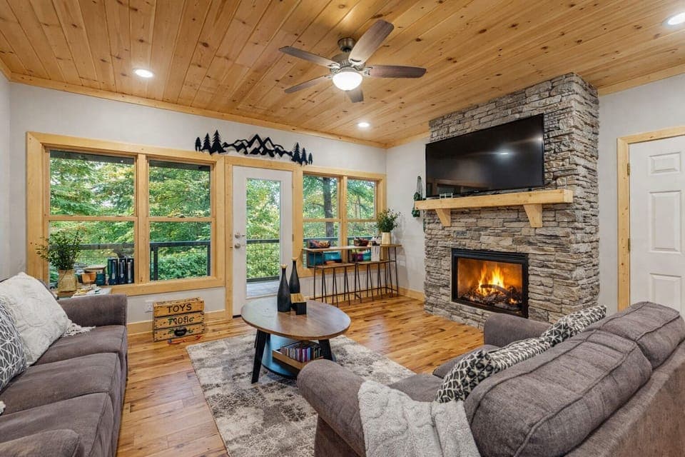 Cozy living room featuring a modern electric fireplace and large flat screen tv