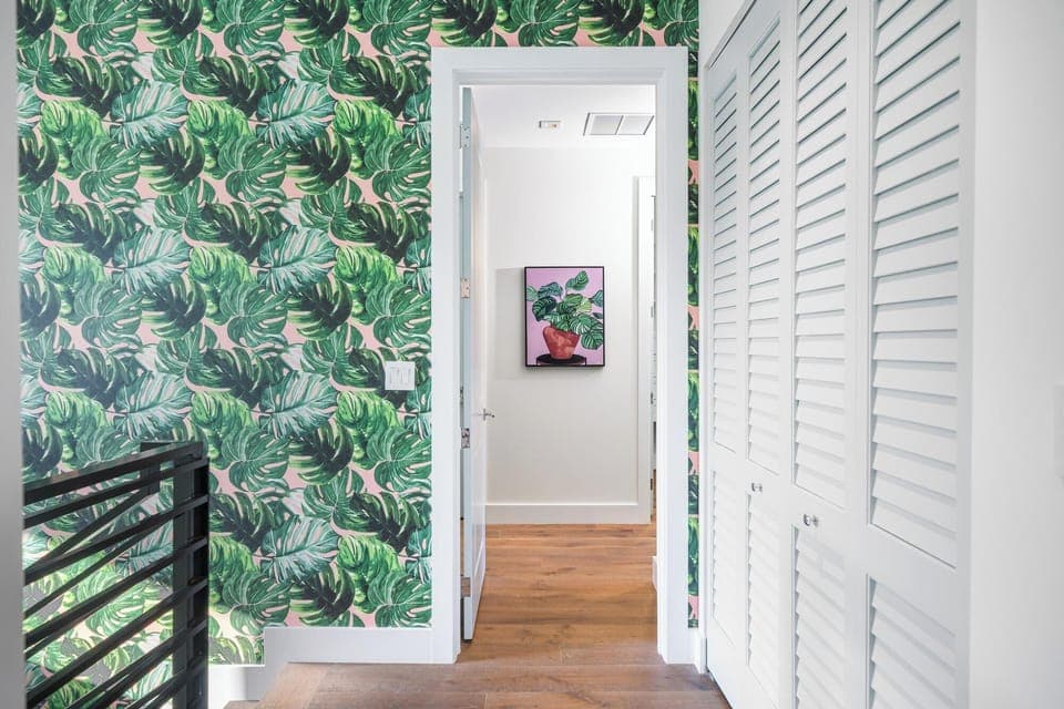 Monstera wall paper design leading upstairs.