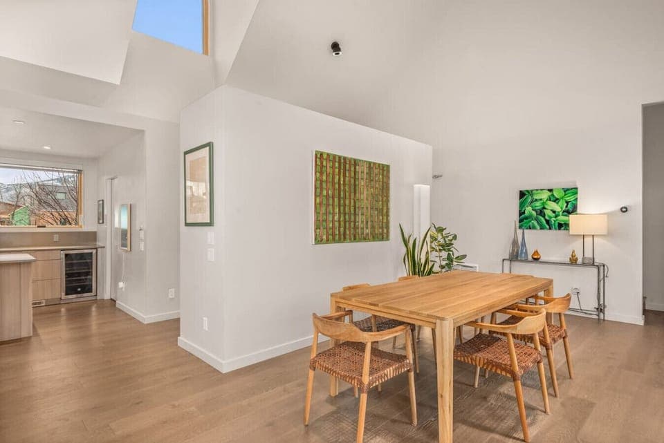 Open Kitchen/Living Area/Dining Area with High Ceilings, TV, Fireplace & Large Windows & Sliding Doors to Backyard
