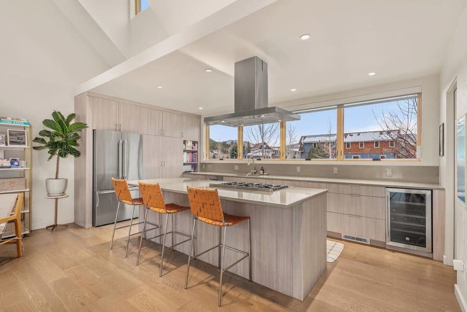 Open Kitchen/Living Area/Dining Area with High Ceilings, TV, Fireplace & Large Windows & Sliding Doors to Backyard
