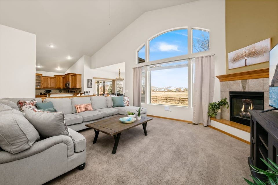 Unwind on the plush sectional sofa while enjoying stunning views and the warmth of your private fireplace in this airy space.