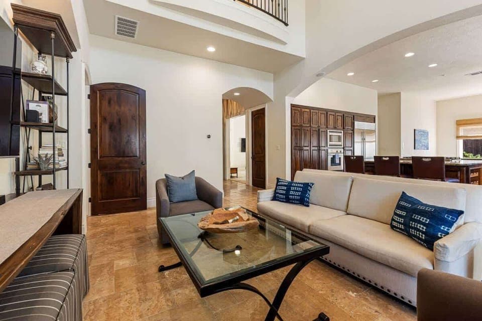 Enjoy a living space designed for relaxation and fun. Watch movies on the large TV, sip cocktails at the bar, or curl up by the fireplace. Bright, airy, and perfect for spending time together.