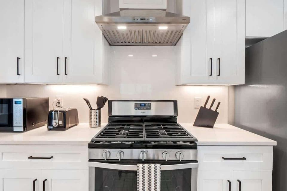 Modern full kitchen with stainless steel appliances, gas stove, dishwasher, and plenty of counter space. Fully stocked with cookware, dishes, and essentials, it’s perfect for preparing family meals or enjoying a morning coffee before exploring Austin