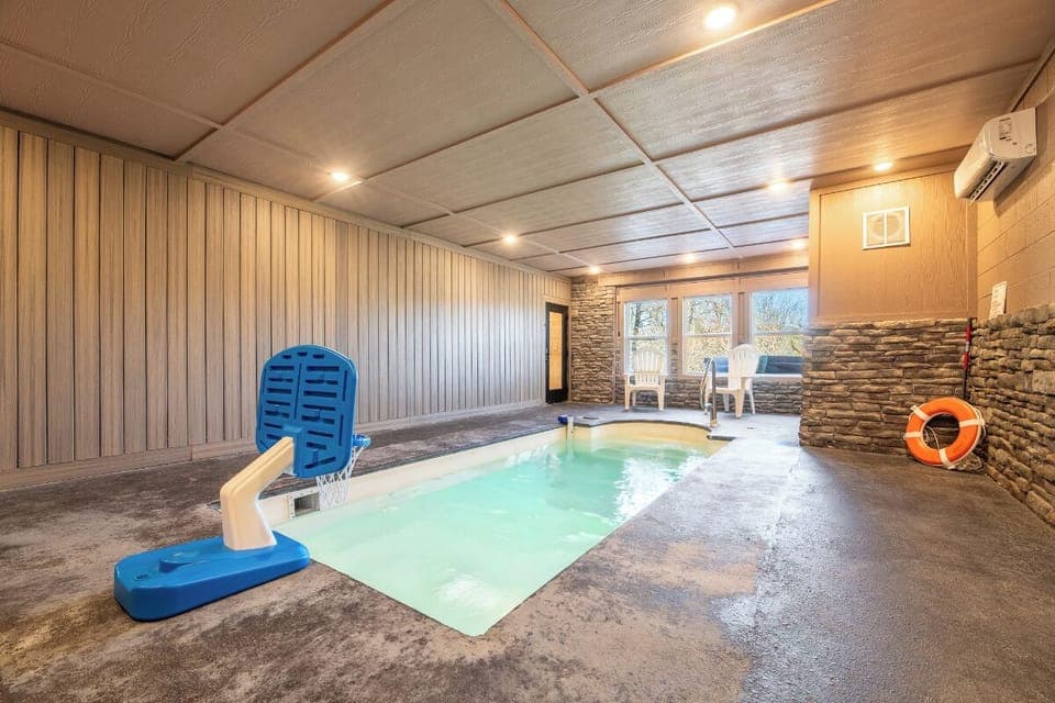 Dive into your private indoor pool sanctuary, where warm waters and stone accents create the perfect retreat.