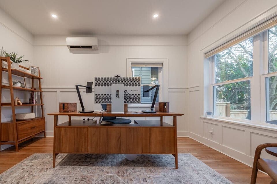 Main-floor office offering a comfortable, fully equipped workspace seamlessly connected to the formal living room.