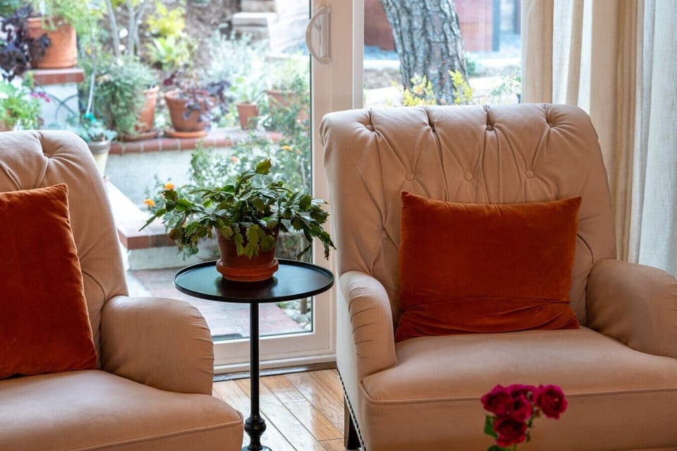 Cozy seating nook by the window, perfect for morning coffee, reading, or a quiet moment to recharge. A warm, comfortable spot that makes everyday living feel easy and relaxed.