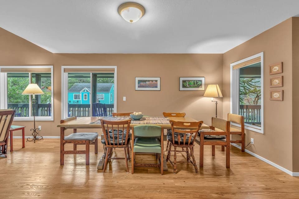 Gather around your spacious dining table where warm wood floors and natural light create the perfect setting for memorable meals together.