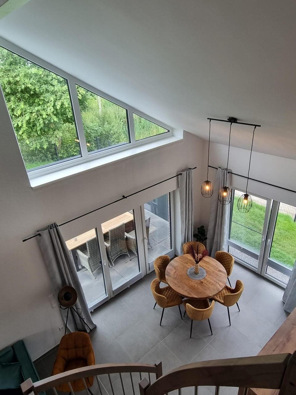 Bright living room with dining area and large windows.