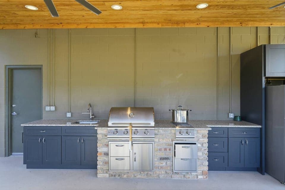 Fully equipped outdoor kitchen with built-in grill and prep space for cookouts.